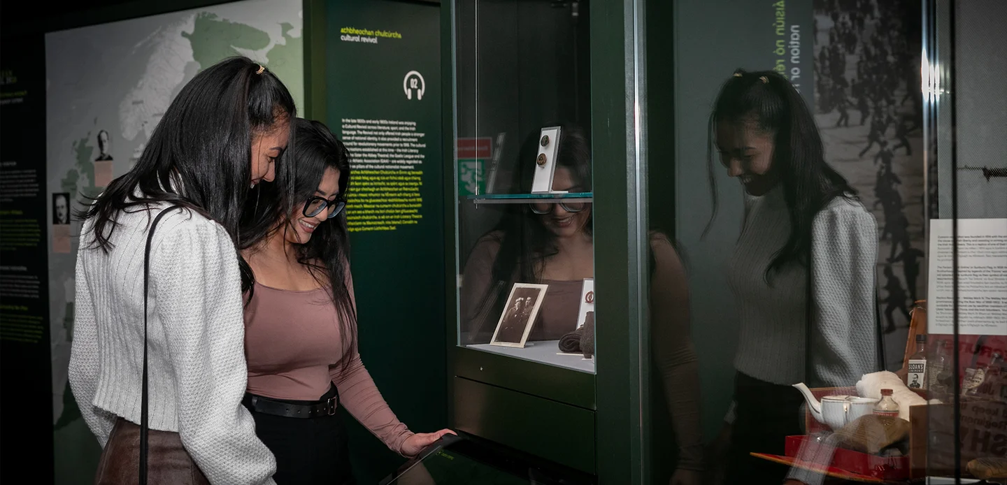 Two visitors examining touchscreen